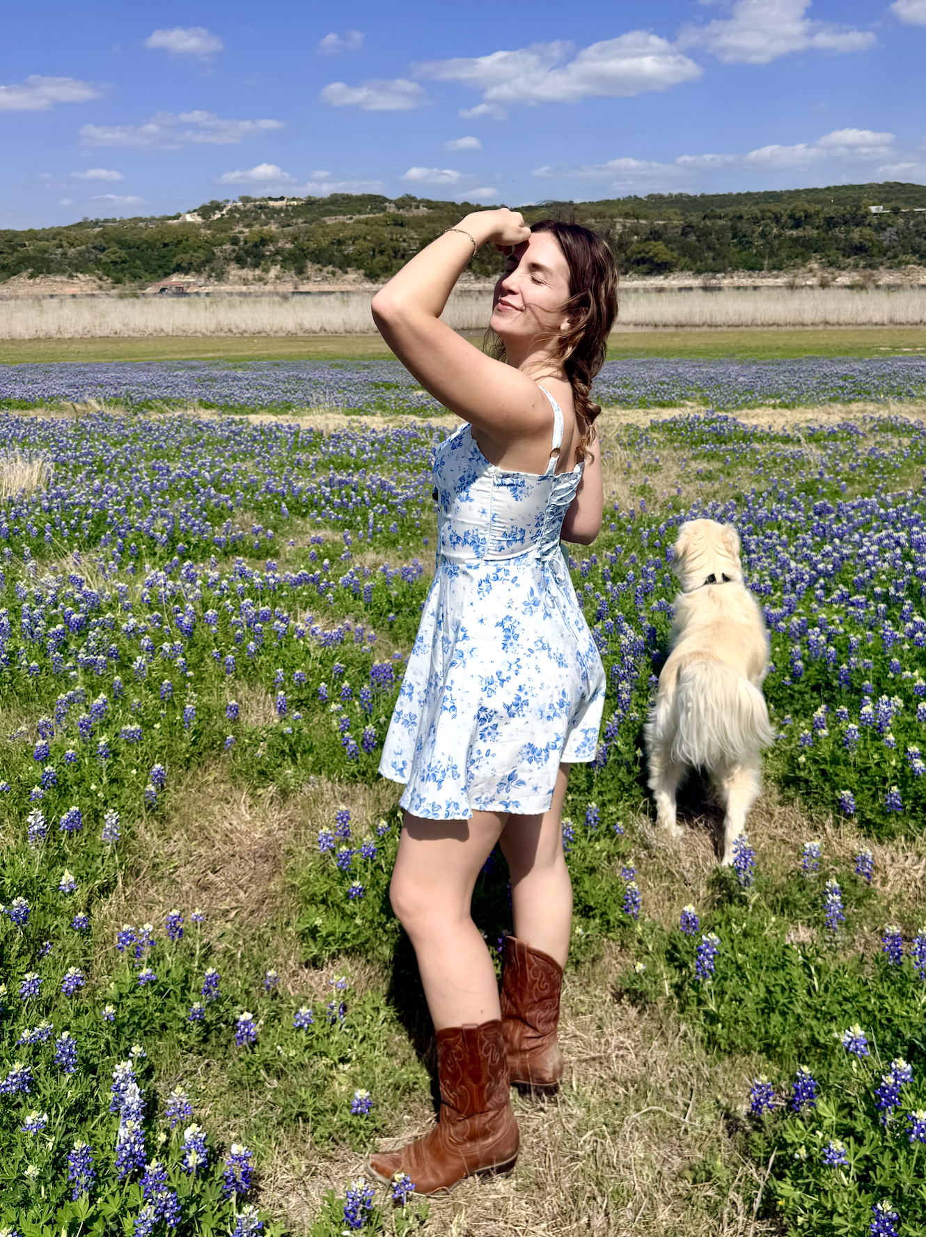 Artist standing in a field of Texas bluebonnets